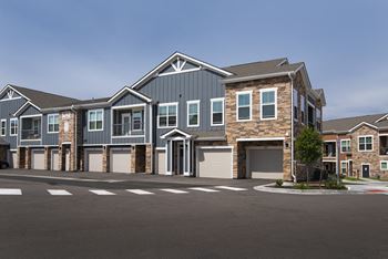 An empty parking lot in front of a house